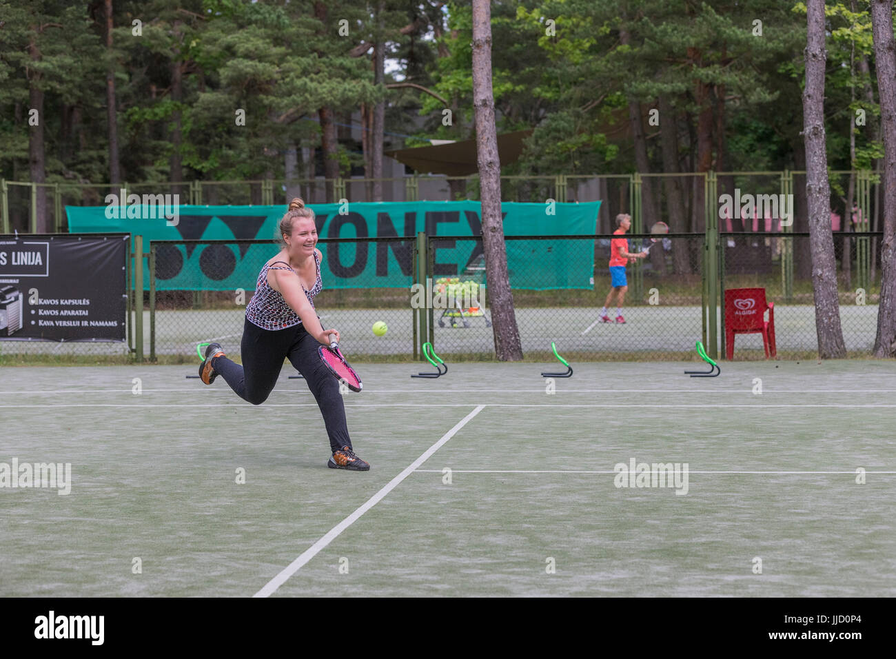 Tennis player hitting ball sur le terrain de tennis, Palanga, Lituanie. Banque D'Images