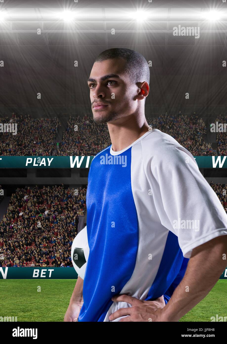 Composite numérique du joueur de football tenant une dans un stade de football Banque D'Images