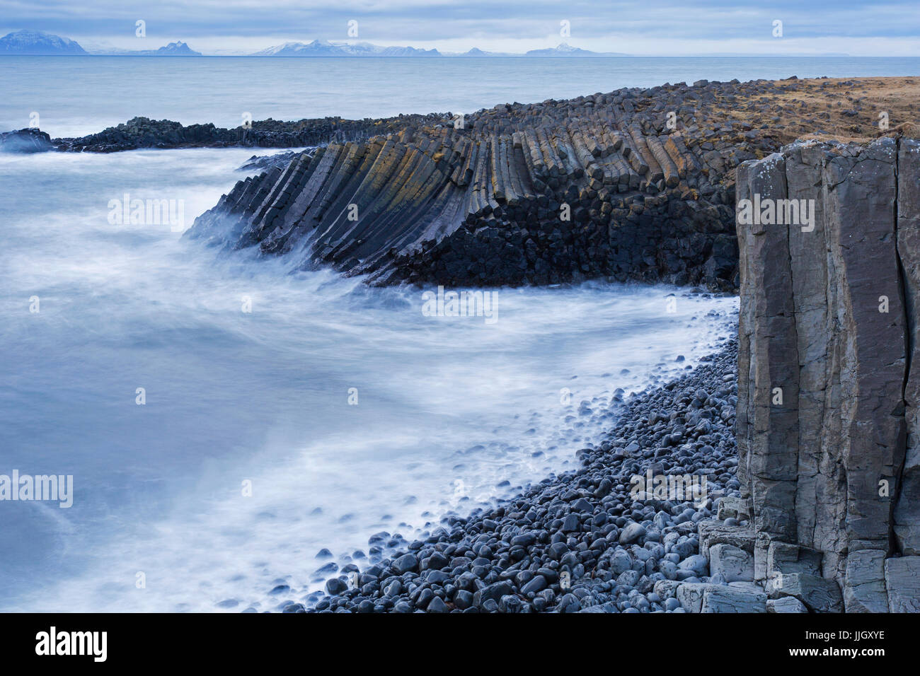 Vagues se brisant sur les colonnes de basalte, des formations de lave volcanique en falaise près de la mer, Kalfshamar Kalfshamarsvik Cove, la péninsule de Skagi, Islande Banque D'Images