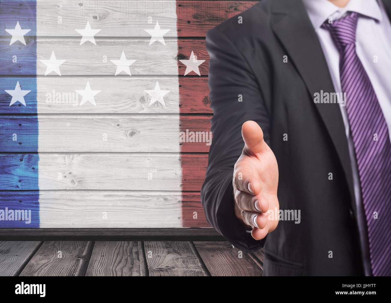 L'homme d'affaires secouant sa main contre drapeau américain Banque D'Images
