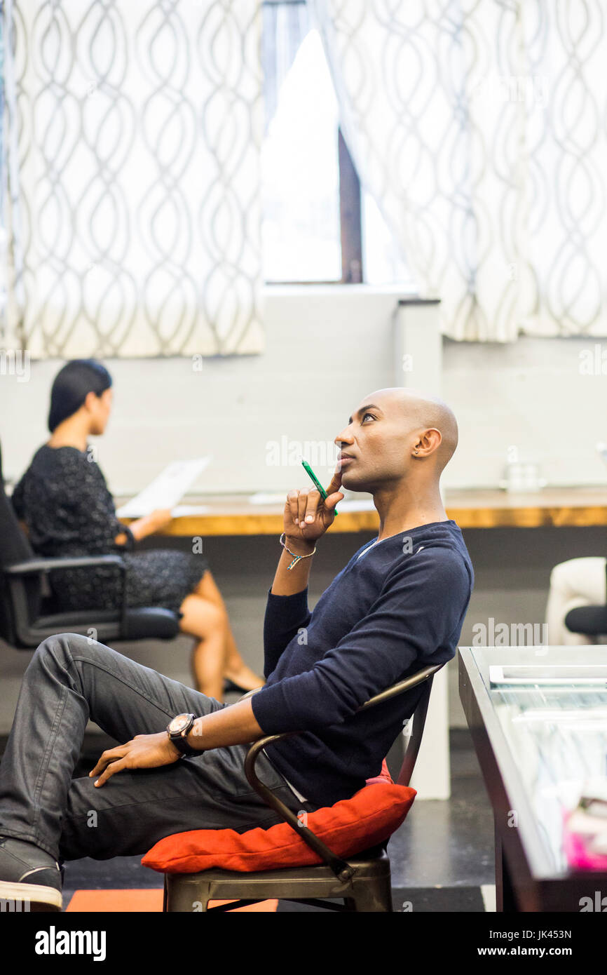 Portrait of smiling African American man sitting in office Banque D'Images