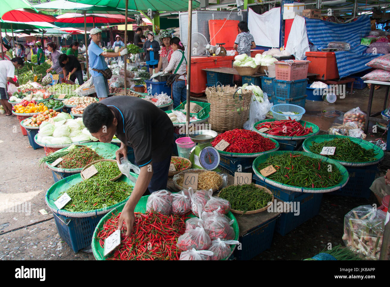 Man selling piments poivrons sur Khlong Toei marché humide, Bangkok, Thaïlande Banque D'Images