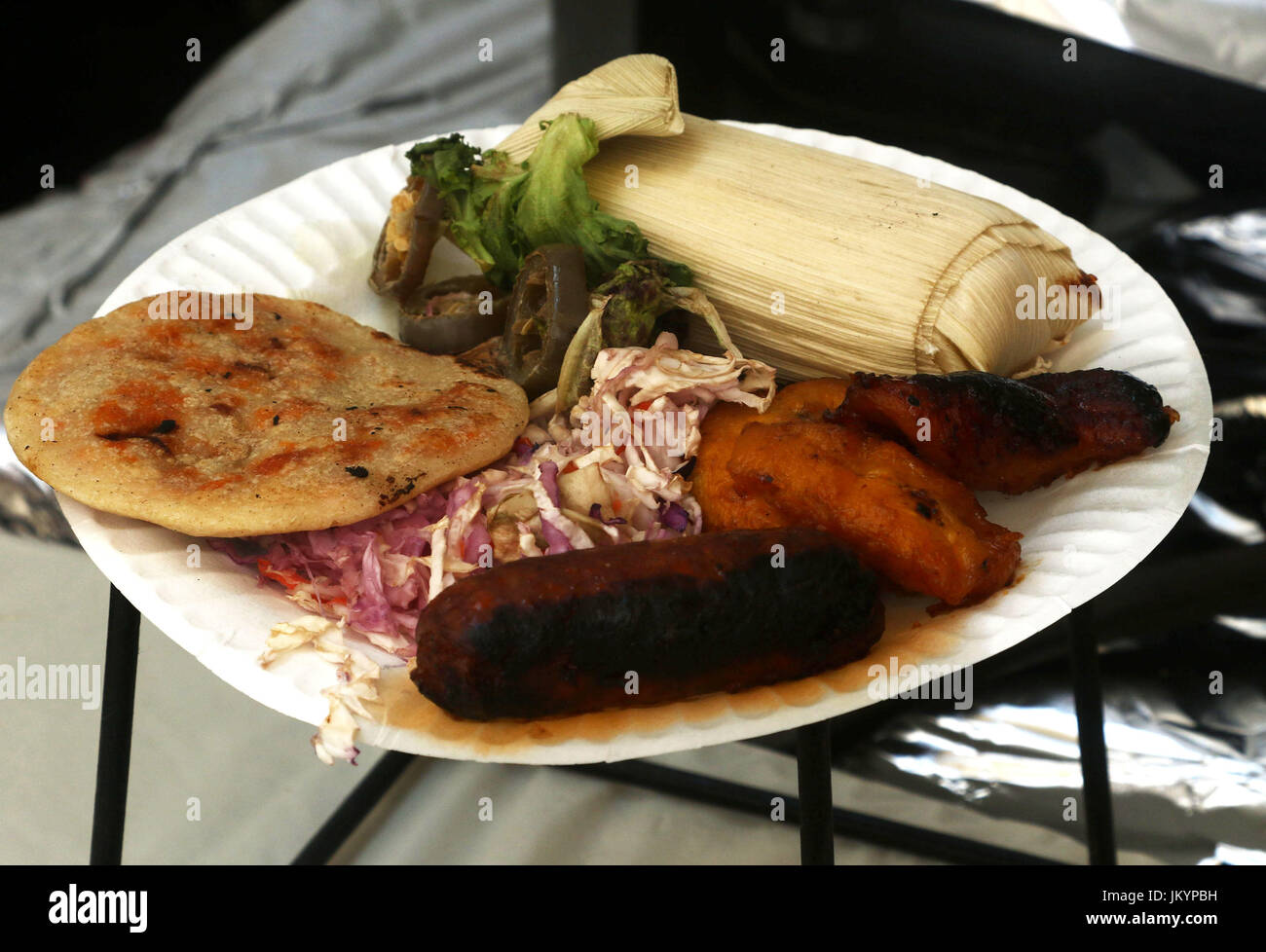 Au chorizo pupusa, sweet plantain, salade de chou, Tamale, et hot peppers Banque D'Images