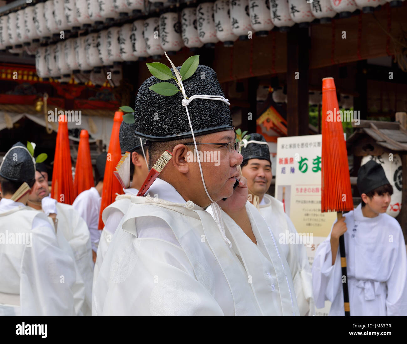 KYOTO, JAPON - 24 juillet 2017 : un homme portant des vêtements traditionnels des pourparlers sur un téléphone cellulaire, comme il attend pour un Sanctuaire Yasaka jinja Gion Matsuri parade Banque D'Images