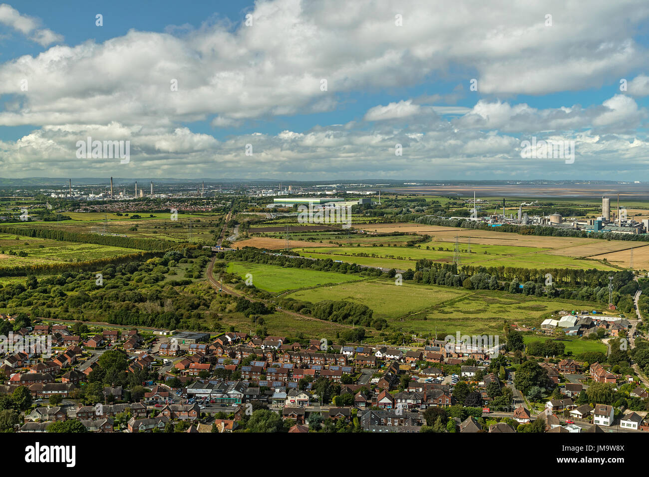 Vue depuis la colline Helsby montrant les zones industrielles de Stanlow et Elton avec la principale ligne de chemin de fer et l'autoroute M56 et les maisons dans le foregro de Helsby Banque D'Images