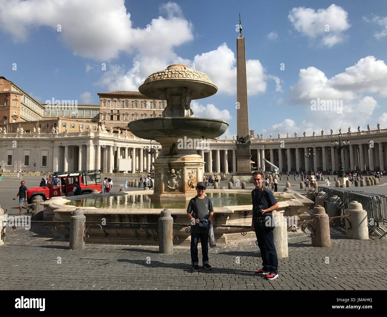 Vatican arrête l'eau des fontaines anciennes à Saint Peters Square, Rome, Italie, 25 août 2017. Mon mari et son fils en face de l'eau calme. Le temps était extrêmement chaud et les touristes ont été constamment courir à l'eau gratuite dans certaines fontaines afin d'étancher leur soif. J'étais l'un d'entre eux. La plupart des fontaines arrêté, mais un peu petite pour la boisson était autorisée, et nous avons tous beaucoup apprécié puisqu'il a été frappant 90-92F depuis quelques jours. Banque D'Images