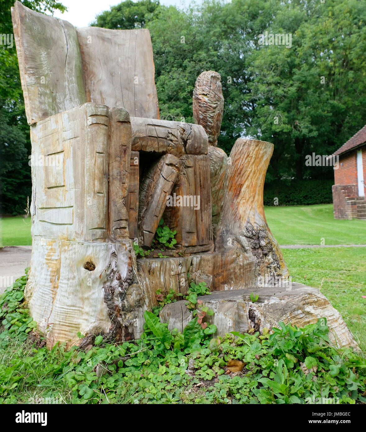 Grande piscine fauteuil avec books et owl, sculpté par une tronçonneuse d'un tronc d'arbre Banque D'Images