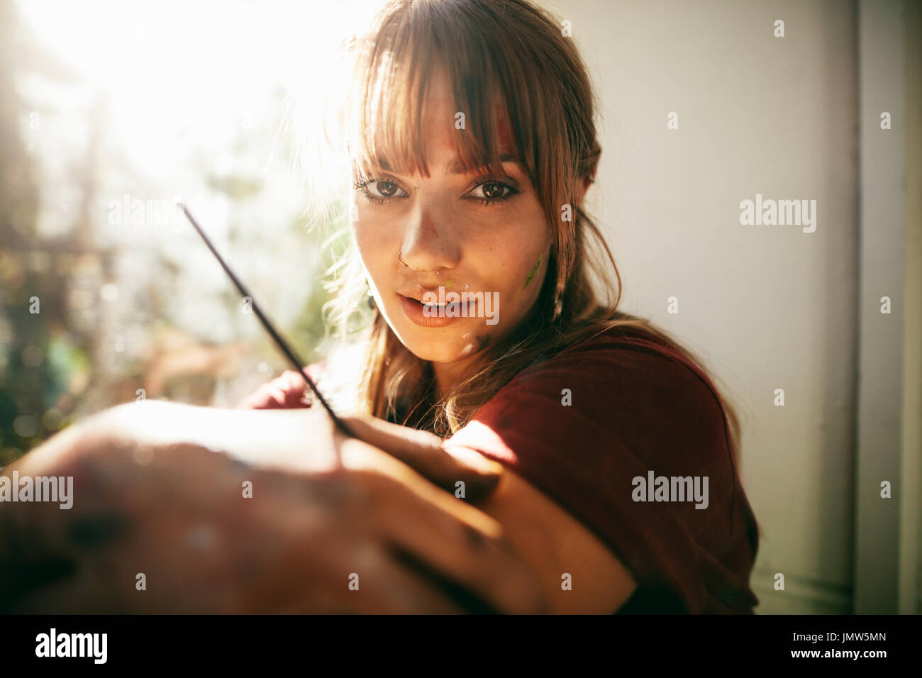 Close up portrait of beautiful young woman artiste. Femme peintre à la recherche à l'appareil photo. Banque D'Images