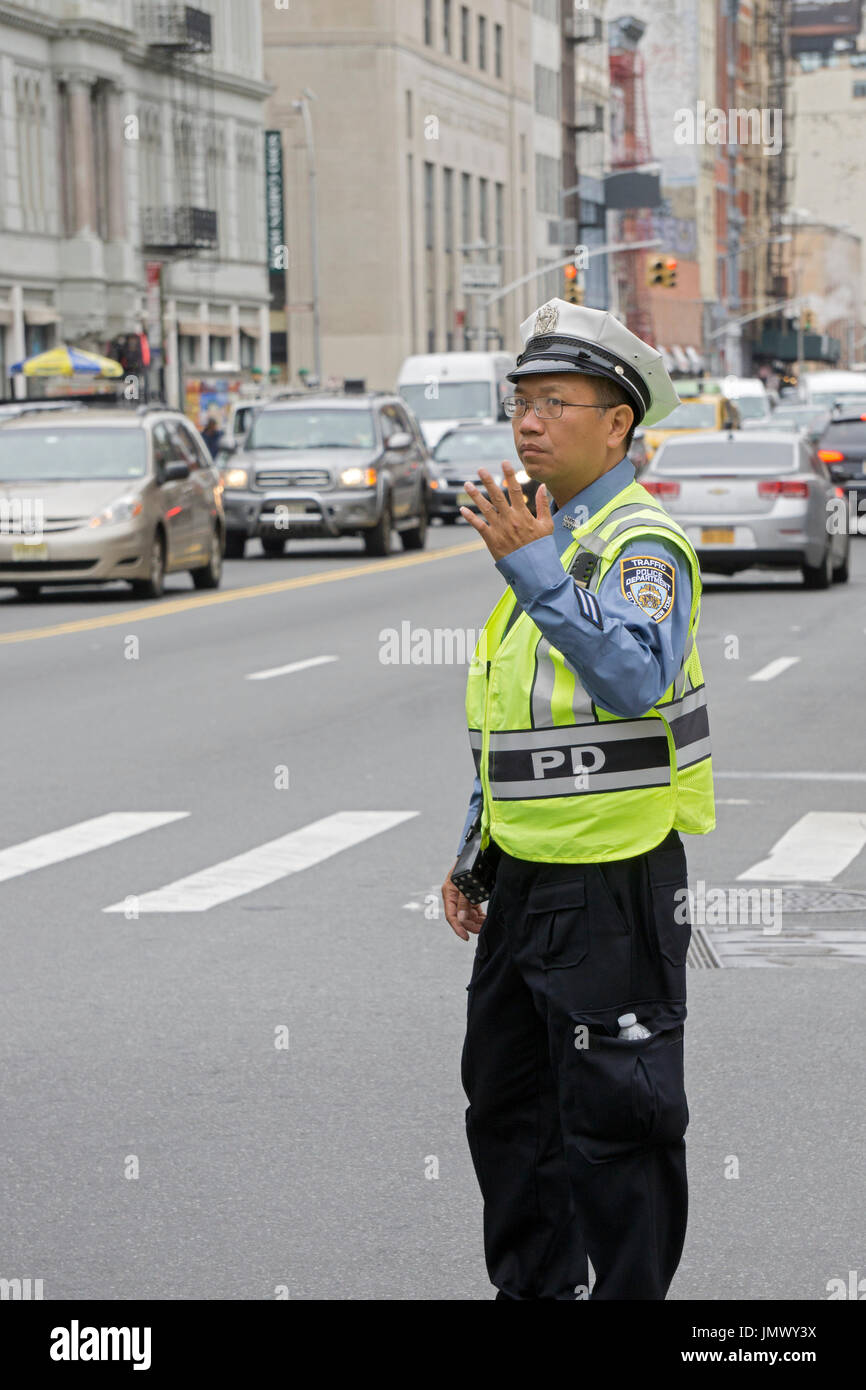 Un homme asiatique de la circulation de diriger la circulation sur Cana Street dans le quartier chinois, Manhattan, New York. Banque D'Images