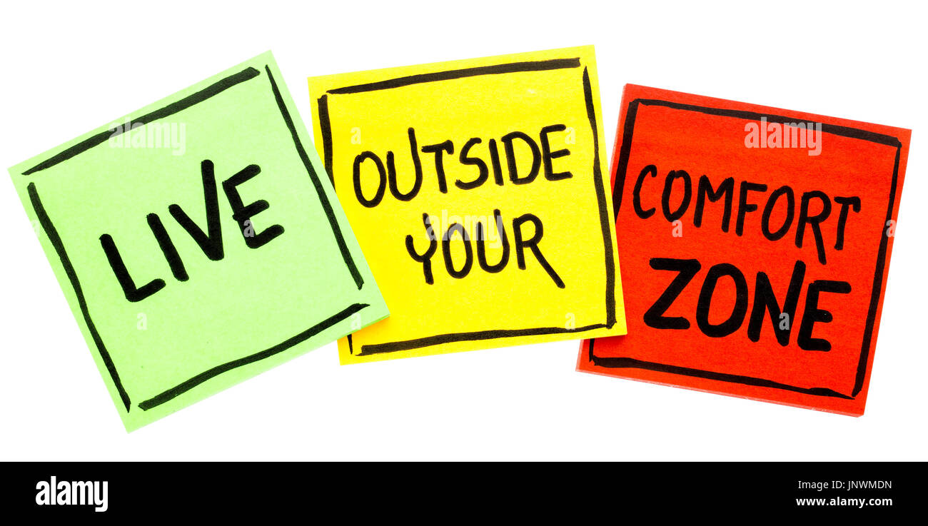 Vivre à l'extérieur de votre zone de confort - écriture de motivation dans l'encre noire sur un post-it Banque D'Images