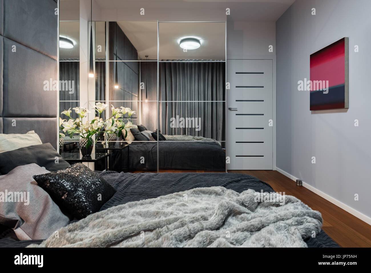 Nouveau design chambre avec lit double, penderie avec miroir et peinture  moderne Photo Stock - Alamy