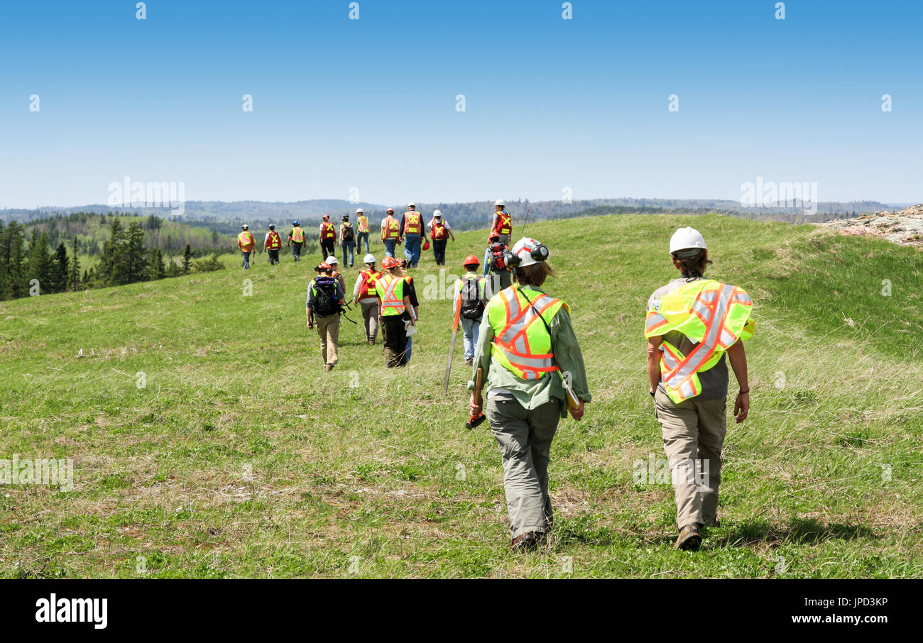 Groupe d'ouvriers en bâtiments et l'inspection à pied grass field Banque D'Images