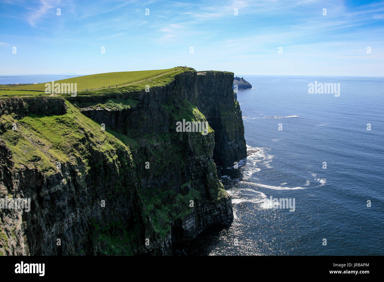 Vue panoramique à l'été les Falaises de Moher, co.Clare en Irlande avec l'océan Atlantique et ciel bleu en arrière-plan Banque D'Images