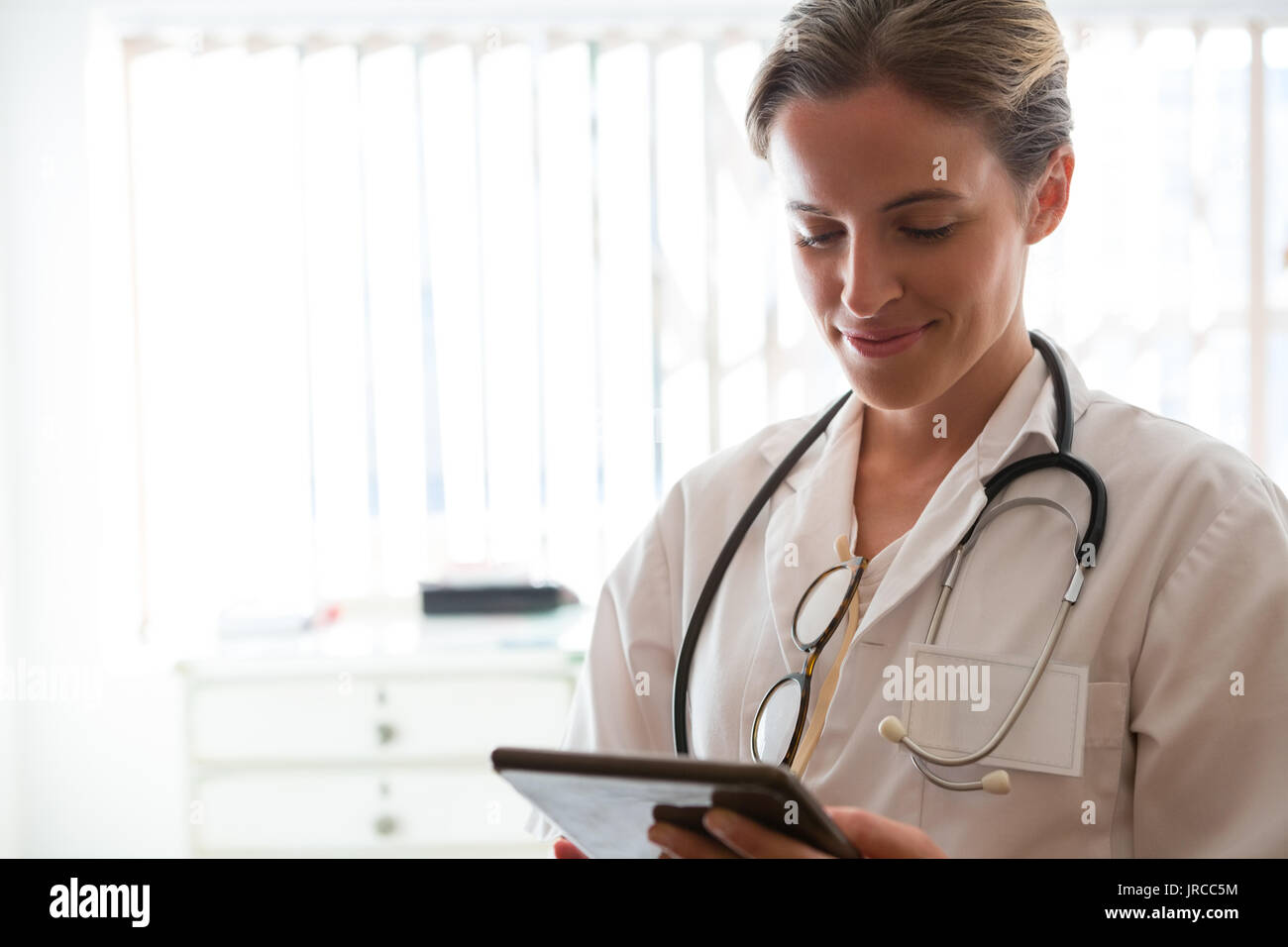 Confident female doctor using digital tablet in nursing home Banque D'Images