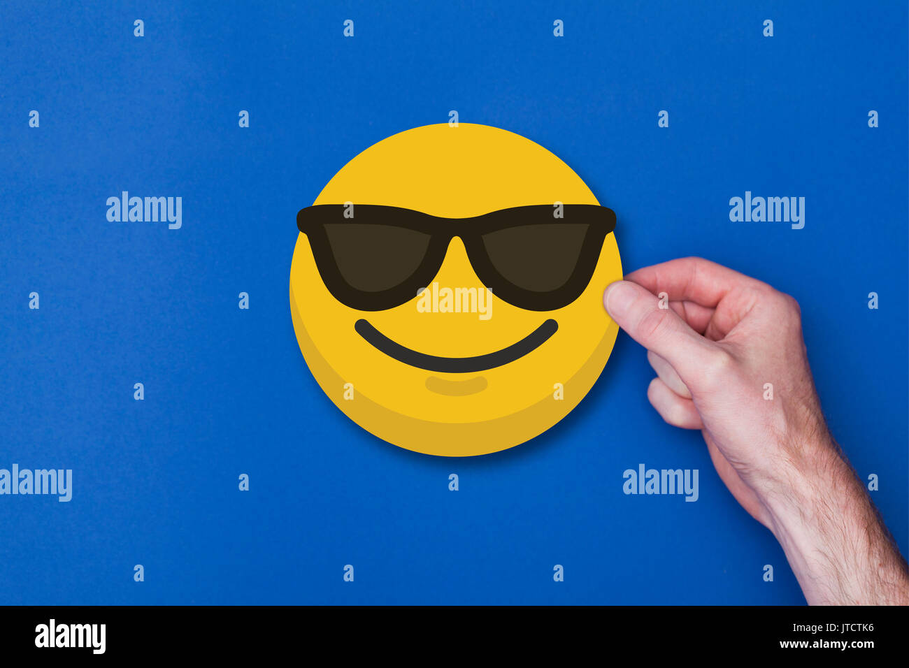 Homme main tenant une émoticône emoji icône smiley chef Banque D'Images