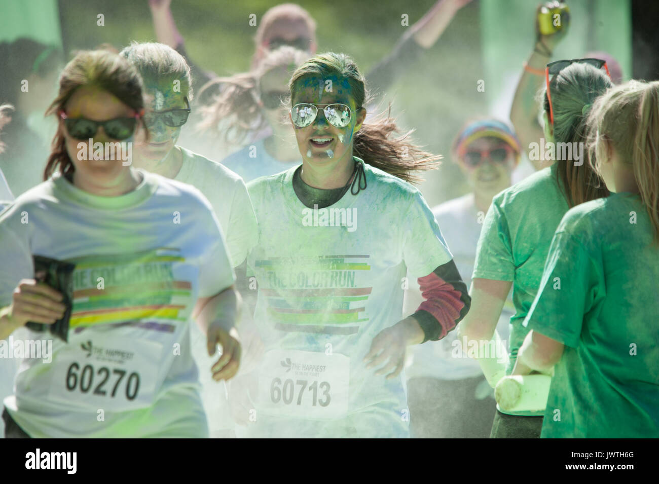 Fille de lunettes de visée dans la peinture et la fumée au cours d'un run de couleur Banque D'Images