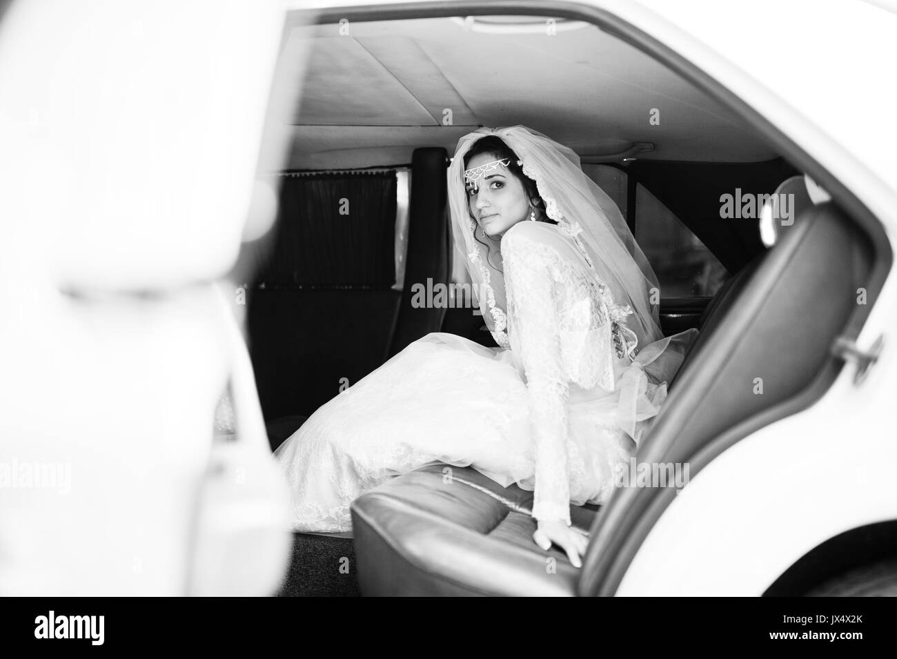 Bride sitting impeccable en voiture de mariage. Photo en noir et blanc. Banque D'Images