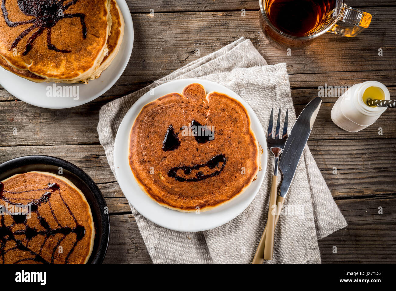 Idées pour le petit déjeuner sont Halloween, les aliments pour enfants. Crêpes à la citrouille décorée avec du sirop de chocolat dans un style traditionnel - araignée, spider, Banque D'Images