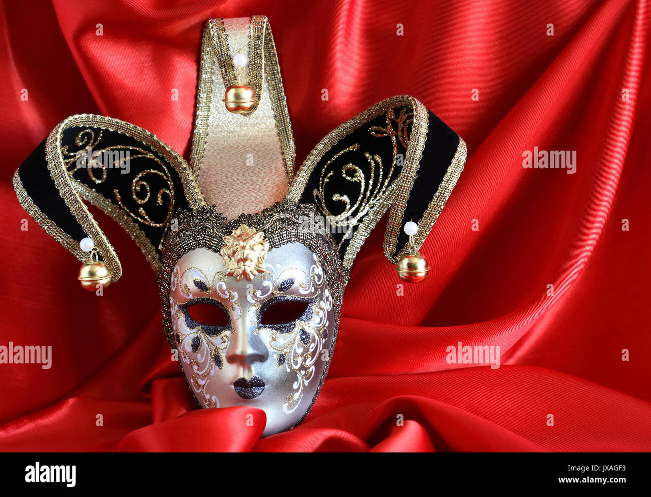 Gros plan du masque vénitien classique sur fond de soie rouge Banque D'Images