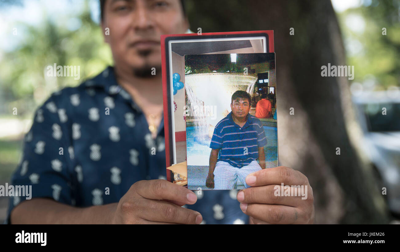 West Palm Beach, Floride, USA. Août 16, 2017. Trente-deux ans Harin Agustin pose pour un portrait tenant une photo de son frère aîné, Eugenio Danilo Agustin, devant son West Palm Beach, Floride, accueil mercredi, 16 août 2017. Le lundi, Eugenio et deux autres hommes ont été placés en détention par des agents de patrouille frontalière près de l'intersection de la 44e Rue et Broadway Avenue. Credit : Andres Leiva/Le Palm Beach Post/ZUMA/Alamy Fil Live News Banque D'Images