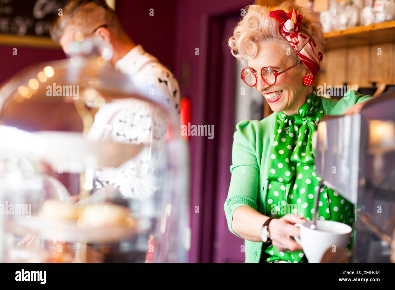 Femme vintage original à l'aide d'une machine à café dans un salon de thé Banque D'Images