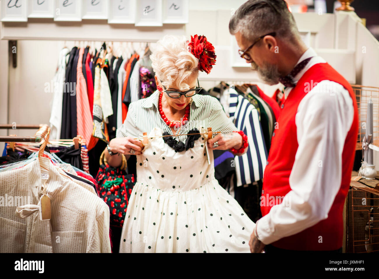 Quirky vintage woman trying dress en ancien et vintage emporium Banque D'Images