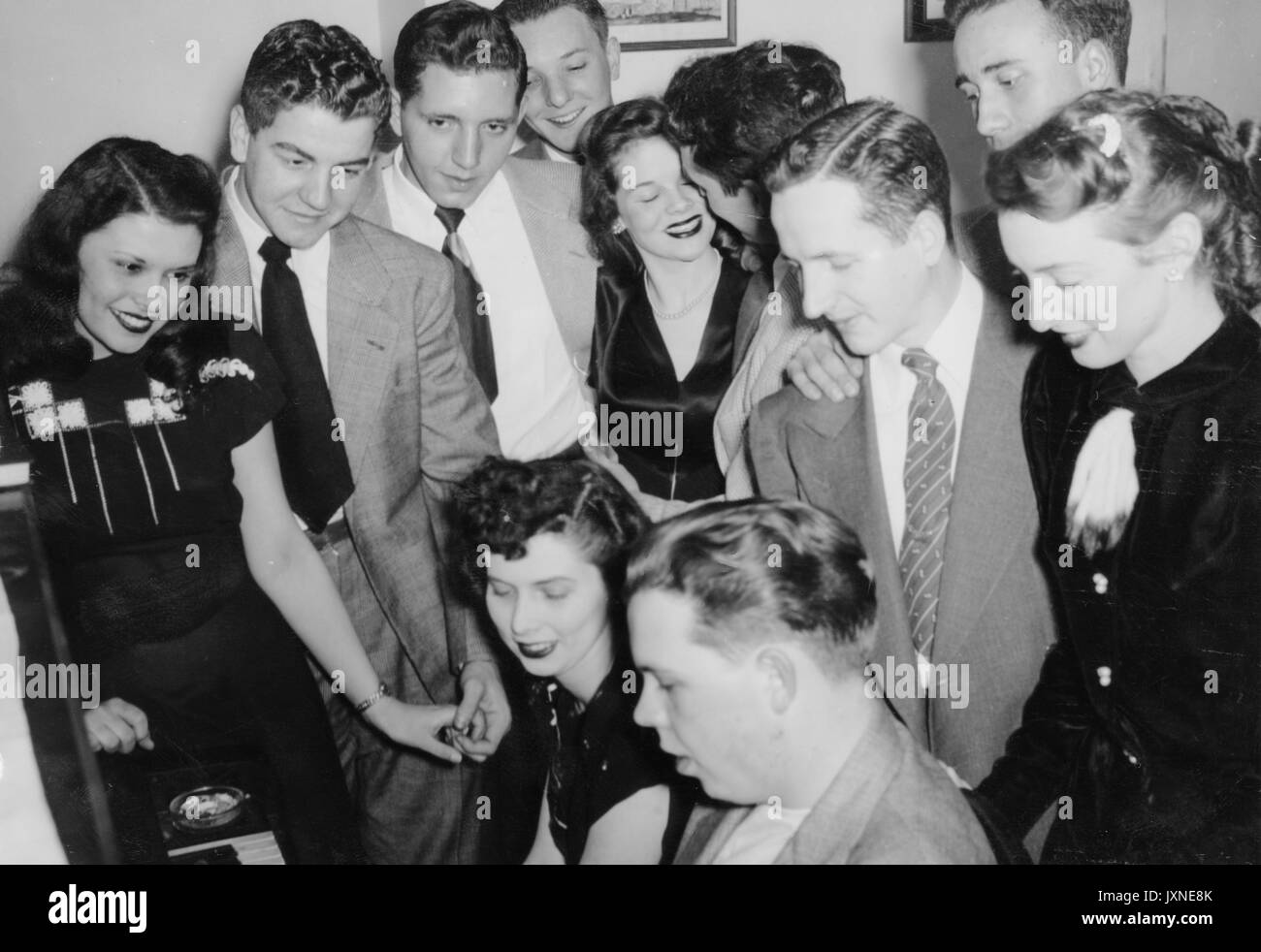Beta Theta Pi, fraternités, Vie étudiante coup franc de fraternité et de leurs petites amies rassemblement autour d'un piano, 1947. Banque D'Images