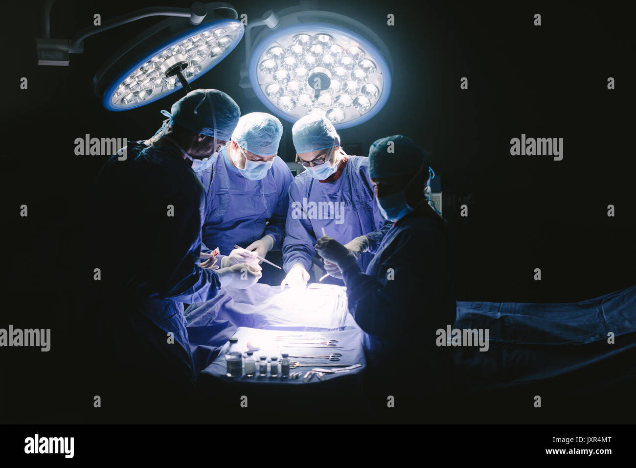 Équipe de professionnels surgeons performing surgery en salle d'opération. Groupe de chirurgien à l'œuvre en salle d'opération. Banque D'Images