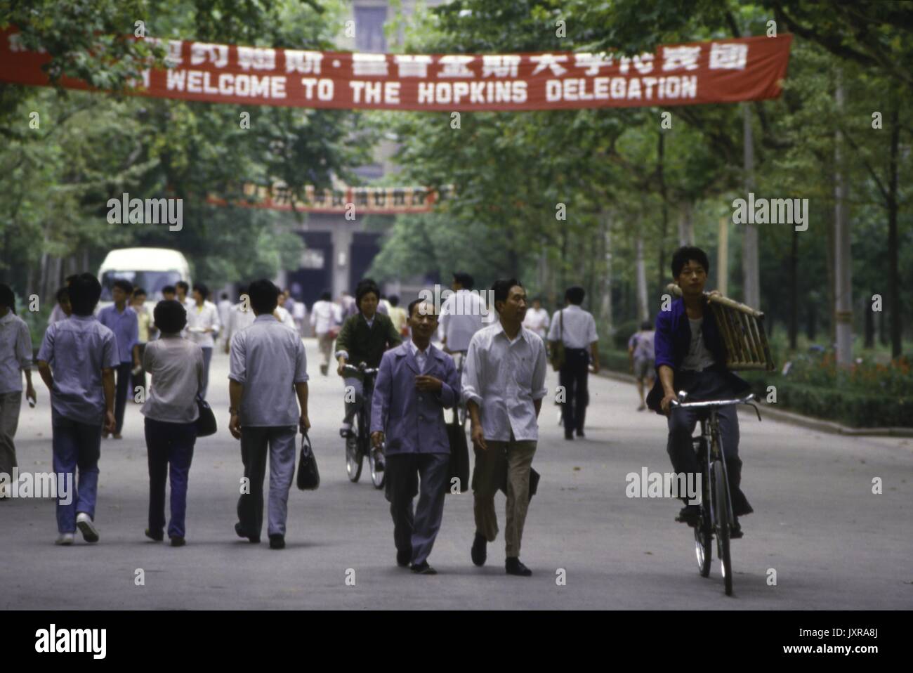 Centre de Nanjing, l'ISC, Hopkins Délégation Nanjing Street scene de personnes à pied et bicyclette sous une bannière pour la délégation Hopkins, 1986. Banque D'Images