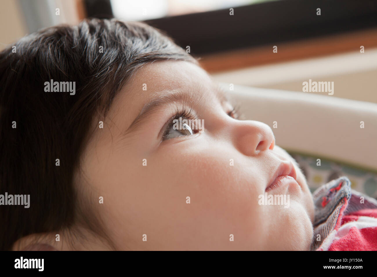 Hispanic baby boy looking up Banque D'Images