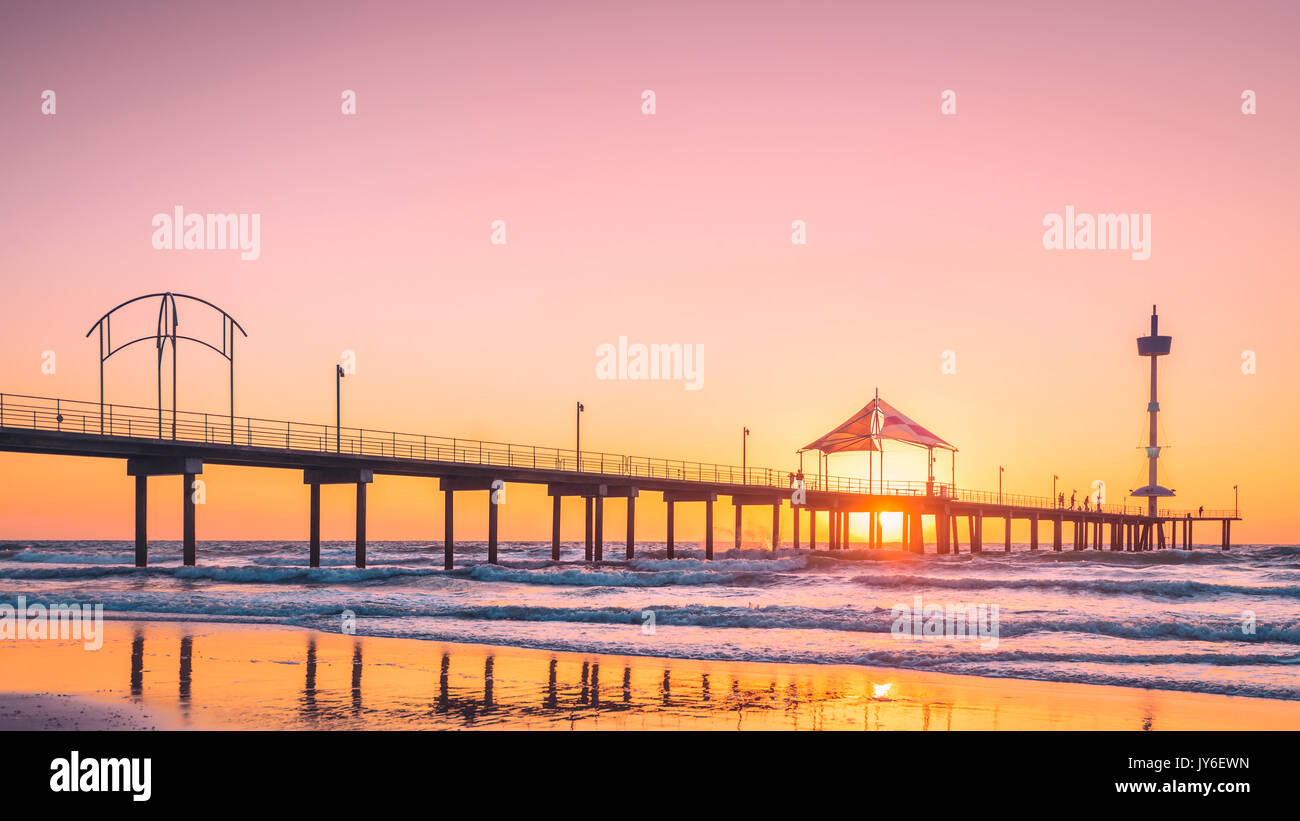 Les gens qui marchent le long de la jetée de Brighton Beach au coucher du soleil, dans le sud de l'Australie Banque D'Images