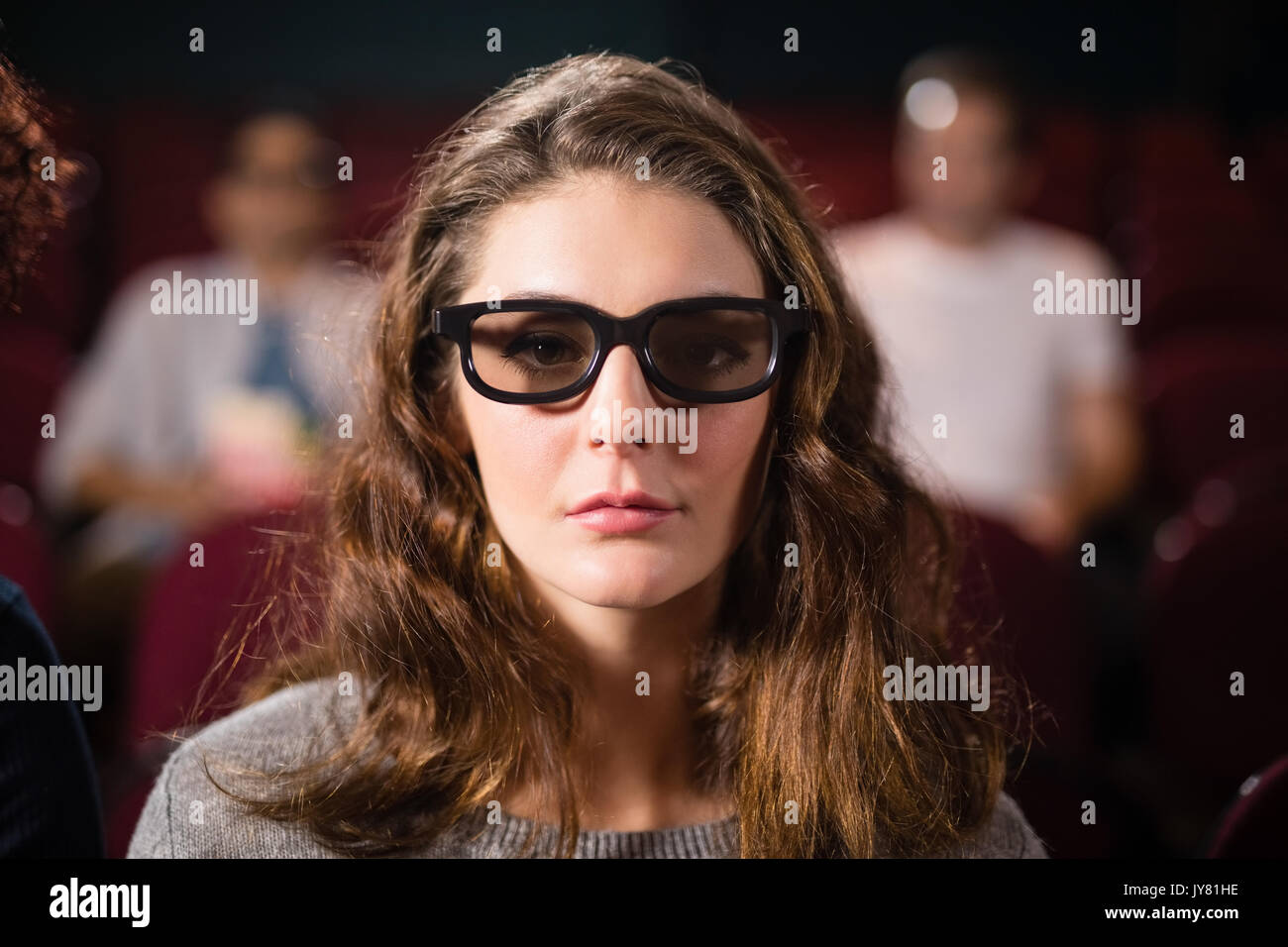 Young woman watching movie in theatre Banque D'Images