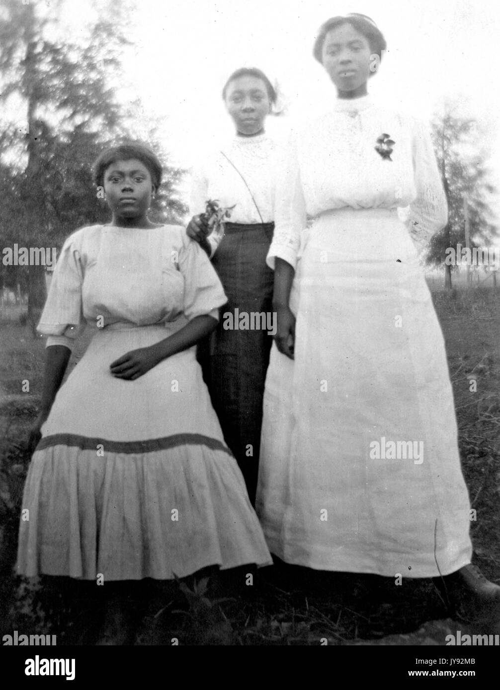 Portrait de mère afro-américaine et des filles portant des tenues, dans le plein air, 1930. Banque D'Images