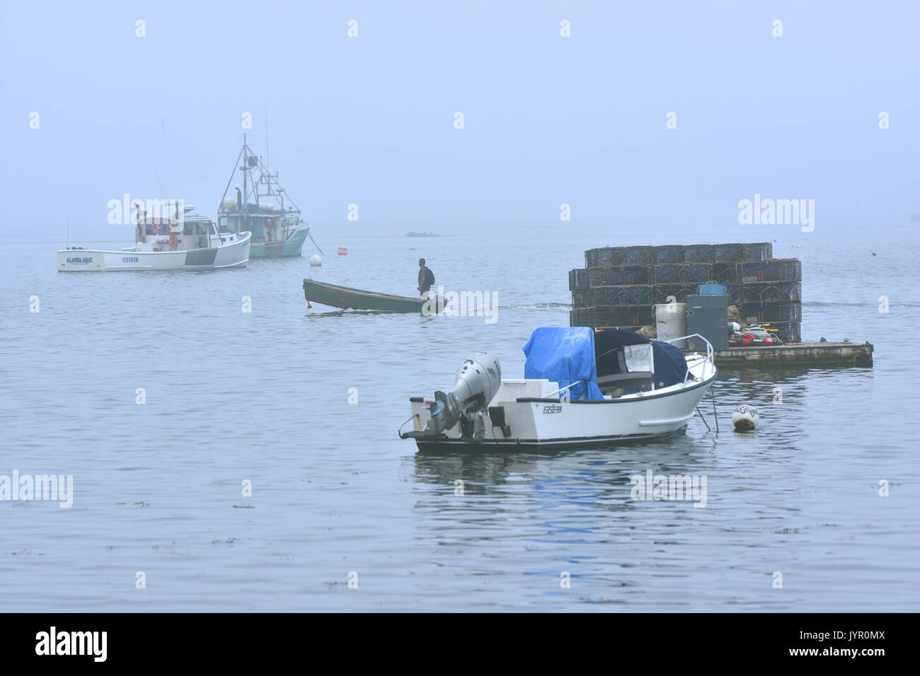 Un fisheman fait son chemin à travers le port de Cundy, Maine le un soir brumeux Banque D'Images