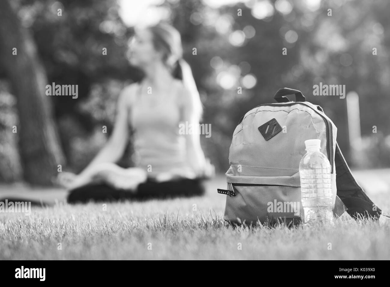 Sac à dos et une bouteille d'eau dans l'herbe Banque D'Images