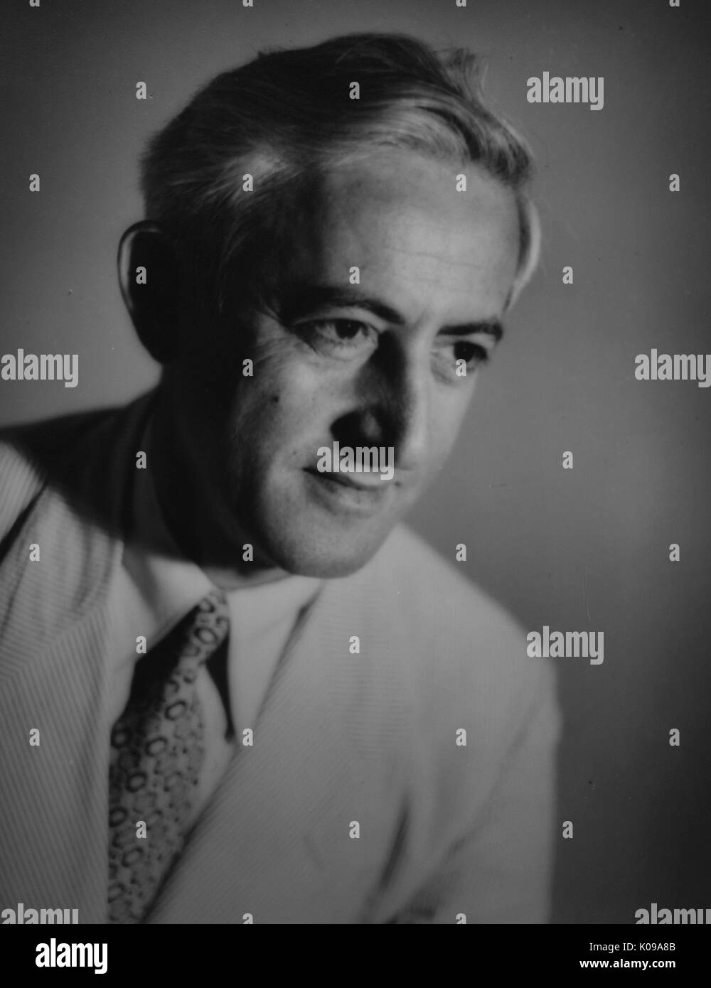 Head-shot du professeur Abel Wolman, vêtu d'un costume de lumière avec une chemise blanche et une cravate à motifs, posé en face d'une toile de fond, avec une expression du visage grave, 1955. Banque D'Images