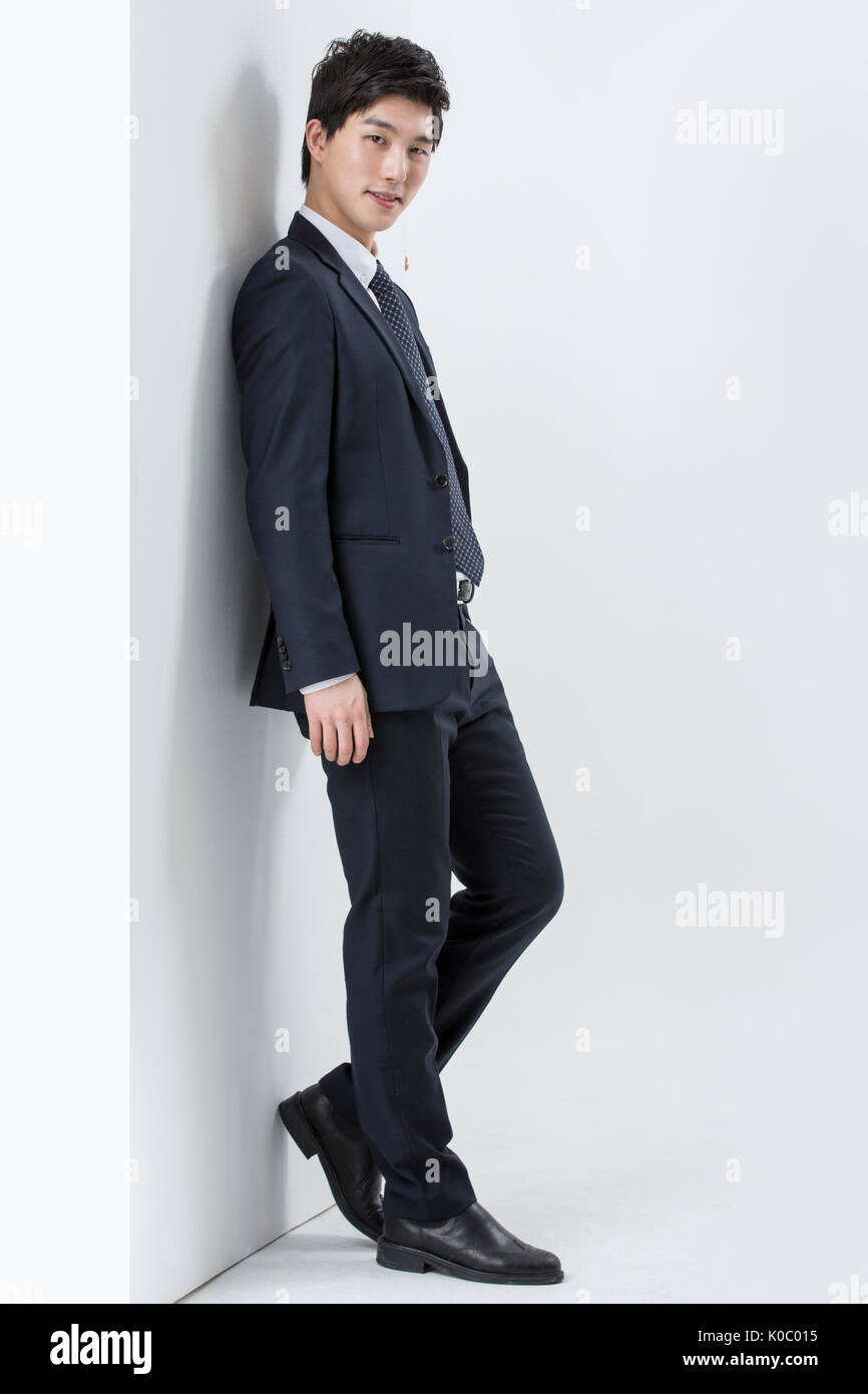 Side view of young smiling businessman standing Banque D'Images