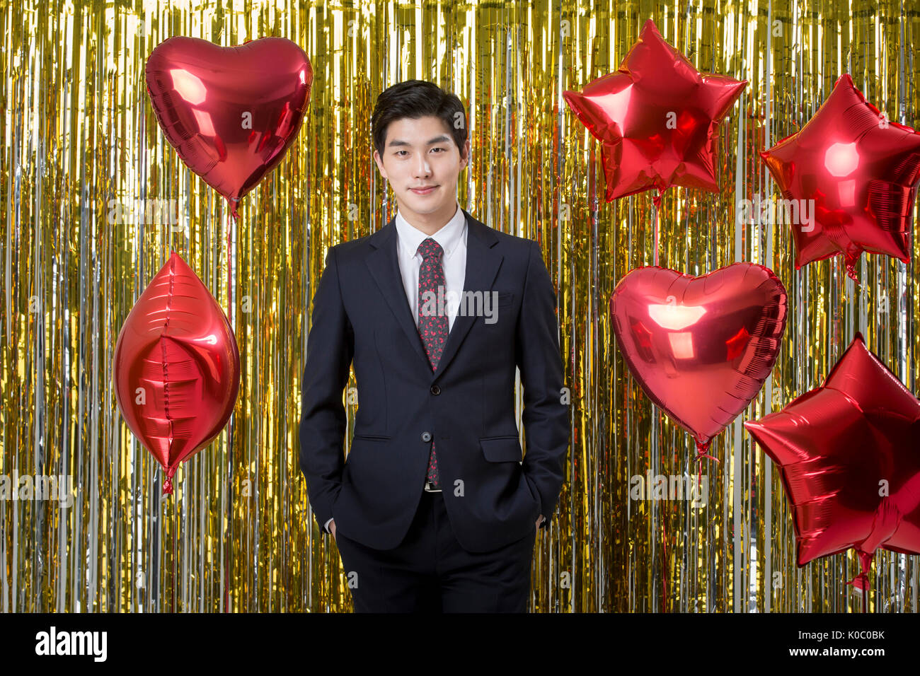 Young smiling businessman in suit posing at party Banque D'Images