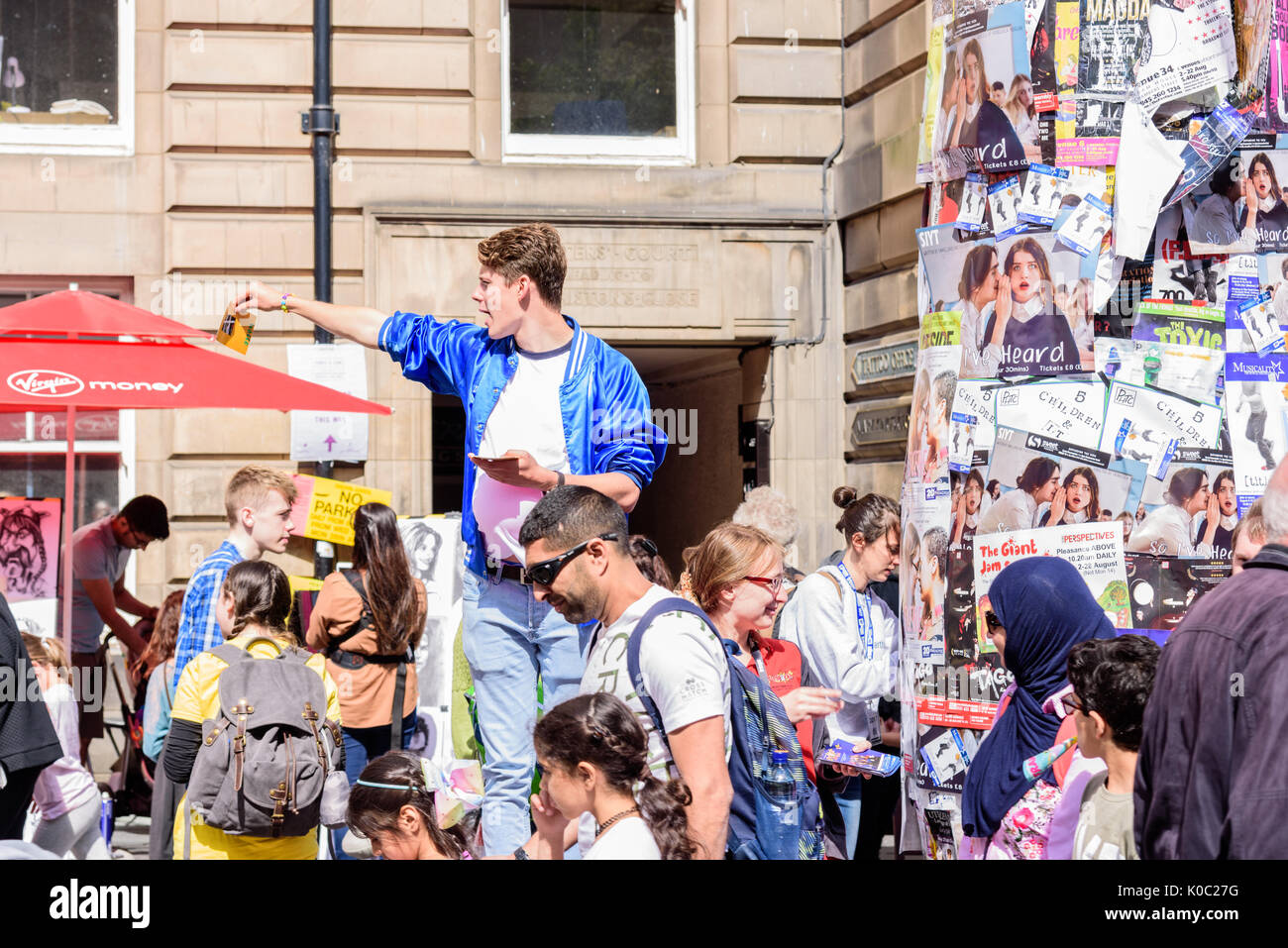 EDINBURGH, Royaume-Uni - 15 août 2017 - Un garçon annonce une performance théâtrale le long de la Royal Mile d'Édimbourg pendant le 70e anniversaire Banque D'Images