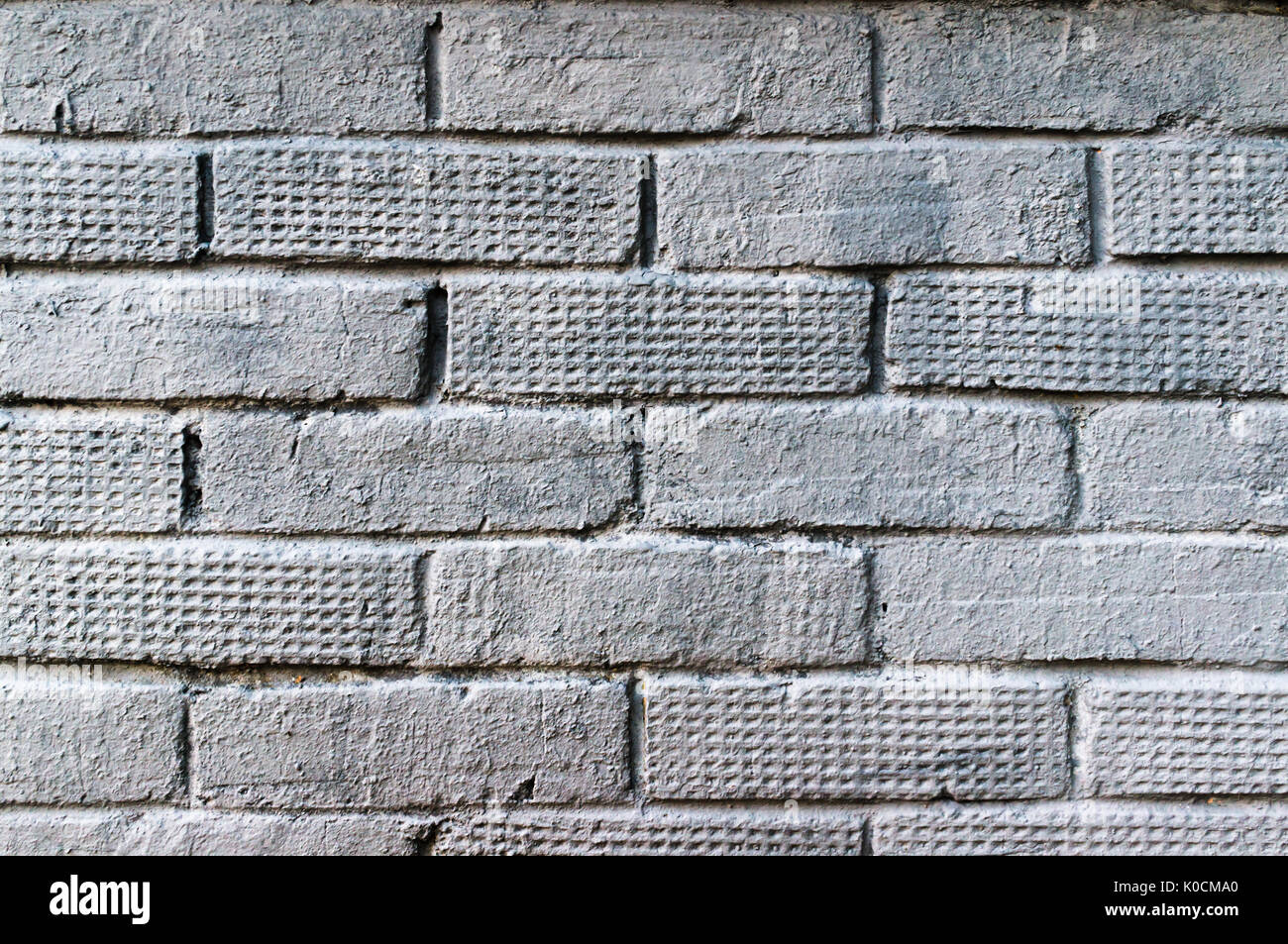 Vieux mur de briques peint en gris. La texture de la brique Banque D'Images