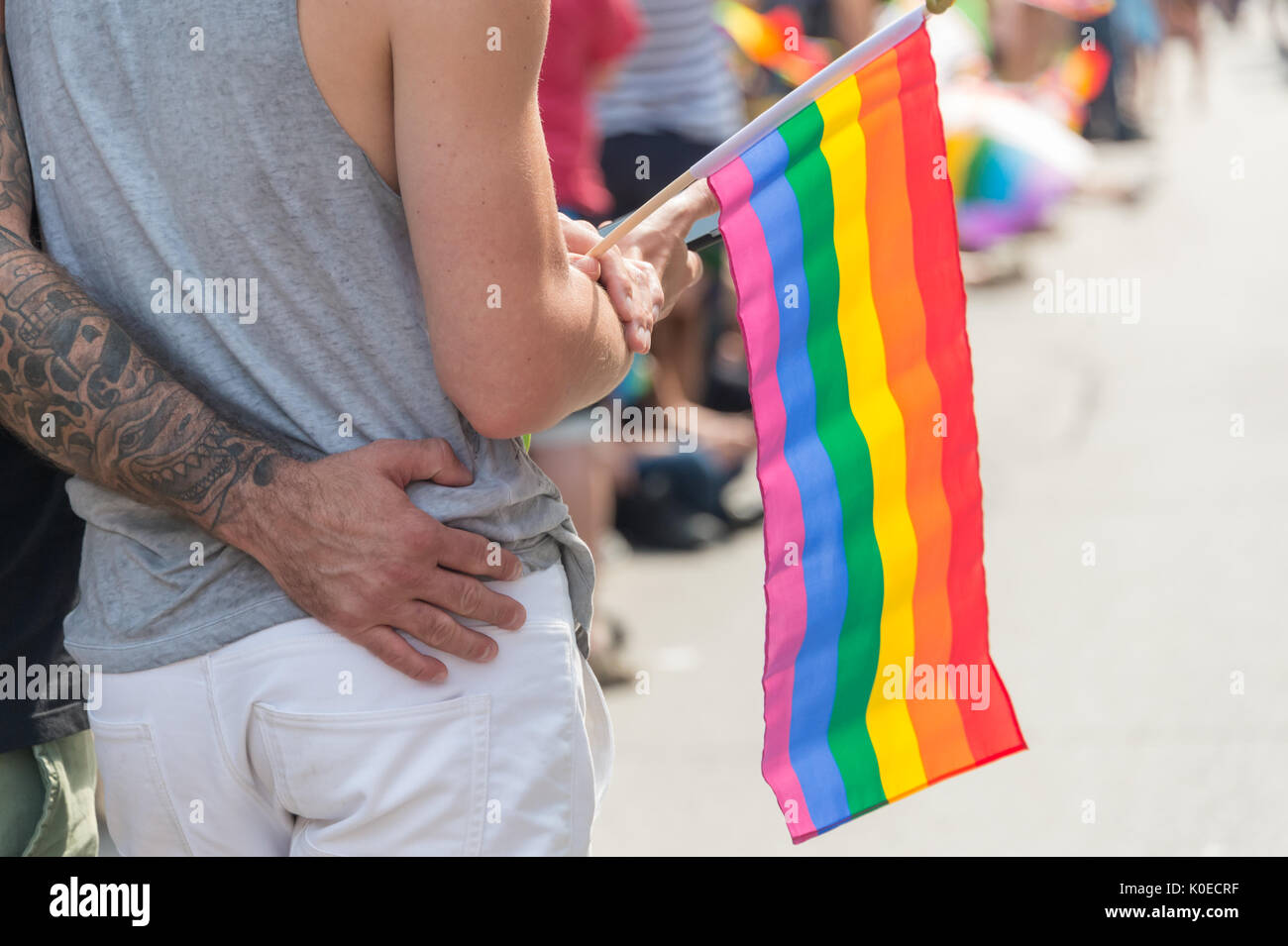 Montréal, Canada - 20 août 2017 : vue arrière d'un gay homme couple tenant un drapeau arc-en-ciel gay gay pride parade à Montréal Banque D'Images