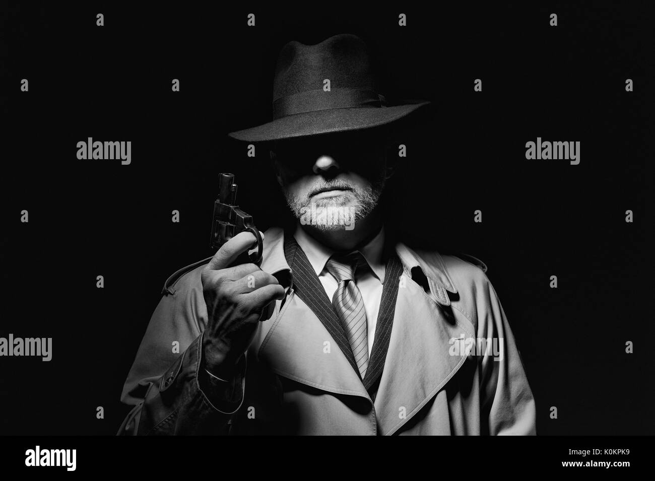 Agent secret tenant un pistolet dans le noir, 1950 personnage de film noir Banque D'Images