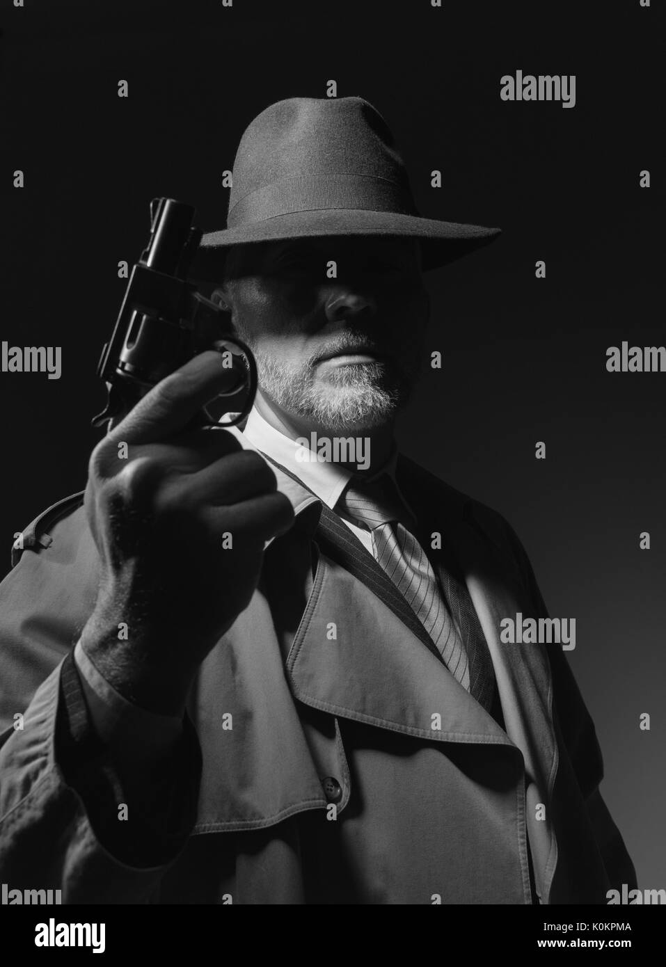 Agent secret tenant un pistolet dans le noir, 1950 personnage de film noir Banque D'Images