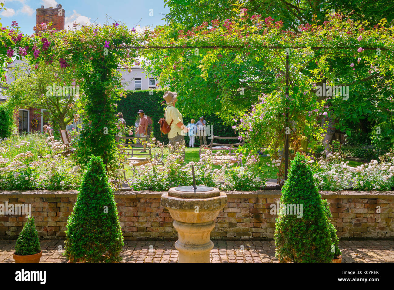 Jardin femme UK, par un après-midi d'été une femme d'âge moyen a l'air autour d'un jardin en jardins ouverts de Bury St Edmunds, Suffolk, UK Jour Banque D'Images