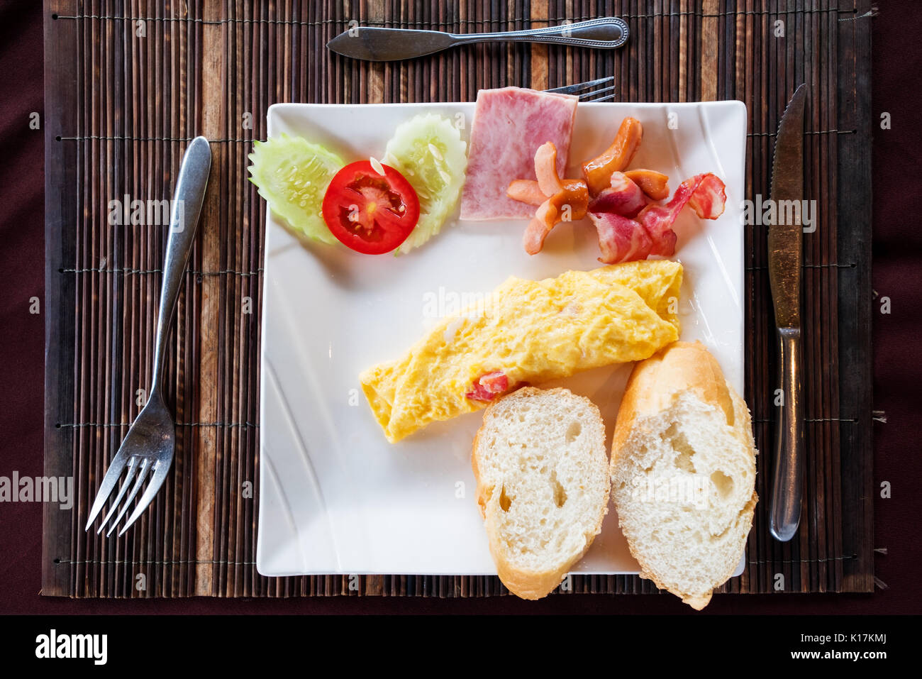 Repas Petit déjeuner, oeufs omelette avec légumes et pains plats sur la table Banque D'Images