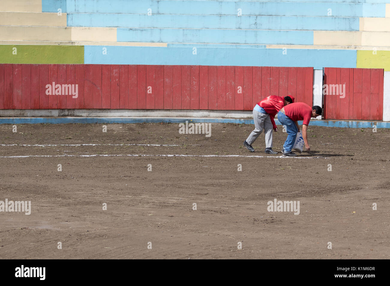 18 juin 2017, Pujili, Equateur : les hommes la préparation de l'arène de tauromachie avant l'événement en marquant des cercles sur le sol Banque D'Images