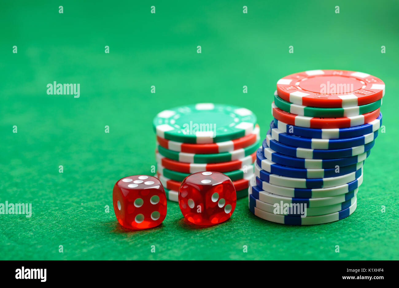 Table verte avec des jetons de casino et de dés. Concept de jeu de Poker Banque D'Images