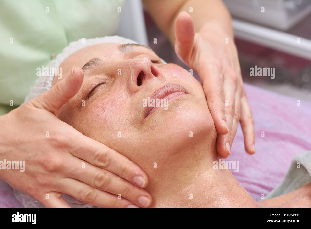 L'application de masque gel mains du visage. Visage de femme mature, cosmétologie. Types de peau et des soins. Banque D'Images