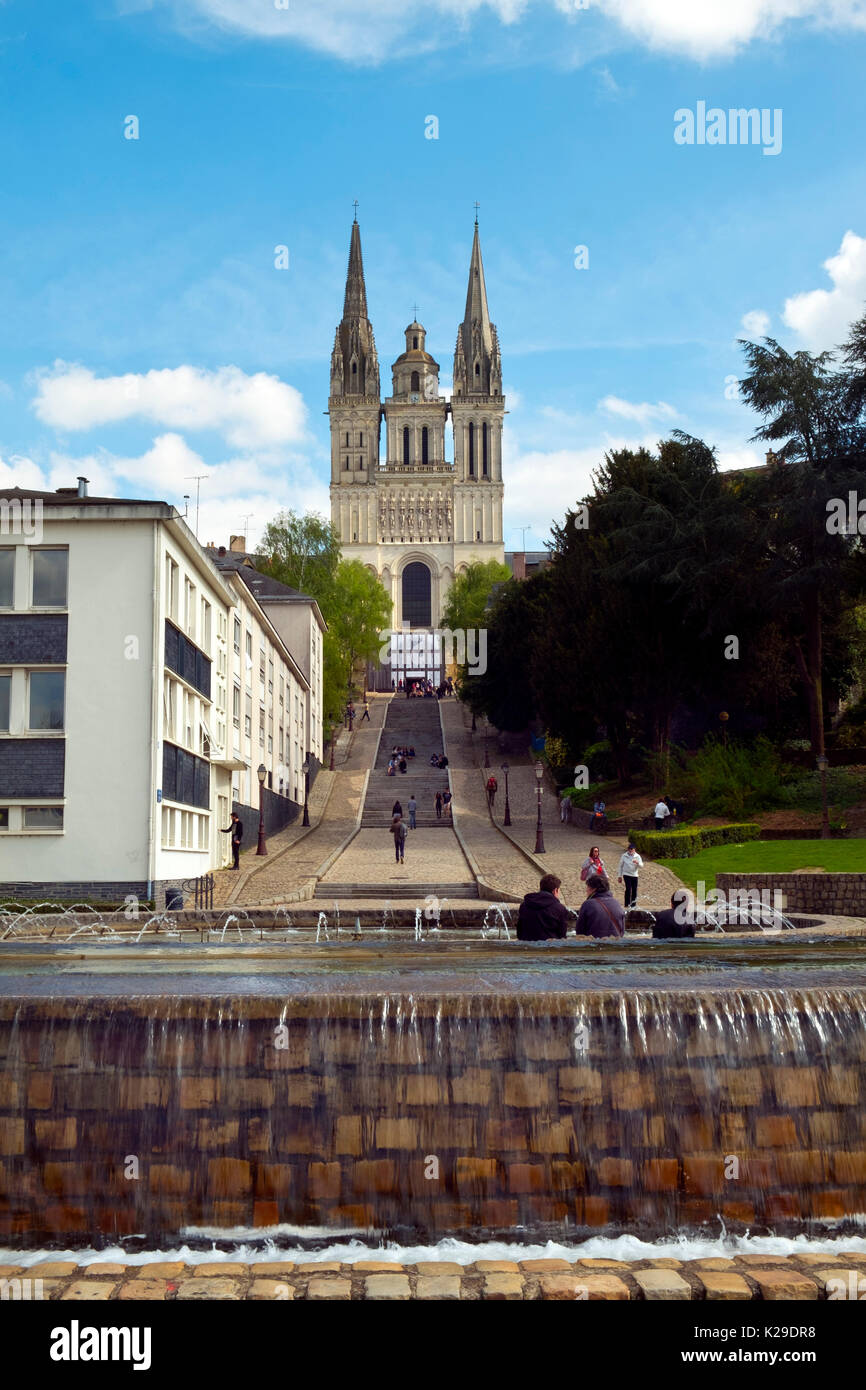 Les jeunes gens se réunissent dans l'après-midi de printemps soleil sur les étapes ci-dessous Cathédrale St Maurice, Angers, Maine-et-Loire, France Banque D'Images