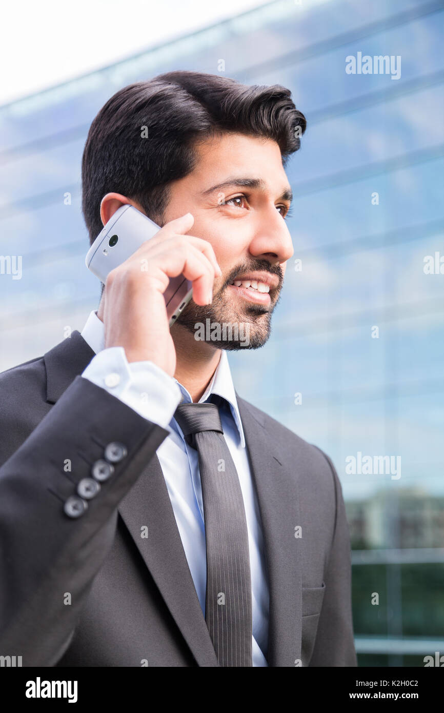 L'arabe smiling happy sérieux d'affaires réussi ou travailleur en costume  noir avec une cravate et chemise avec barbe appelant avec son téléphone  près de son oreille l'article Photo Stock - Alamy